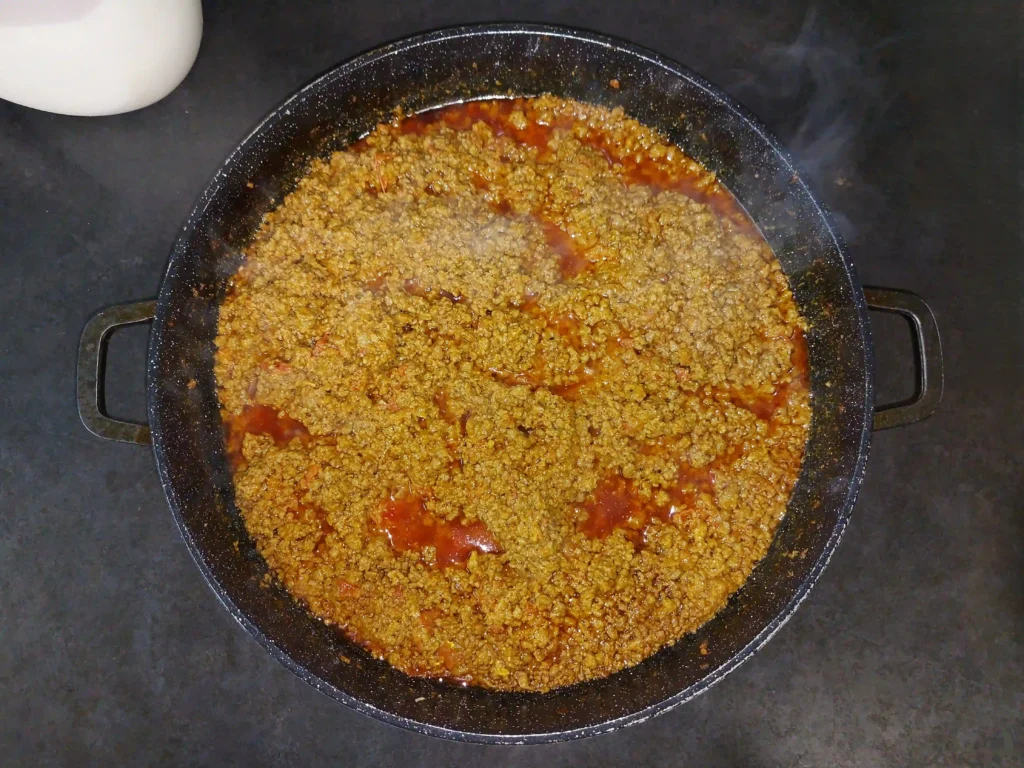 Adding remaining ingredients of masala to cooked keema