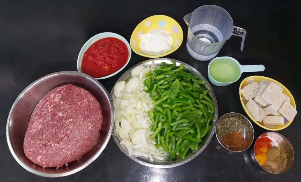 All ingredients required for keema (minced mutton, tinned tomatoes, Greek yoghurt, water, yellow onions, green bell peppers, sunflower oil, lemon juice, crushed garlic, spices)