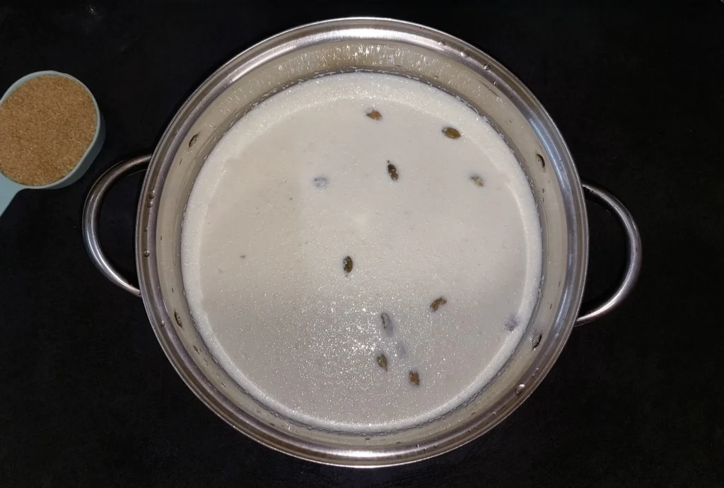 Rice and milk for kheer (rice pudding) mixed with other ingredients in pot before cooking
