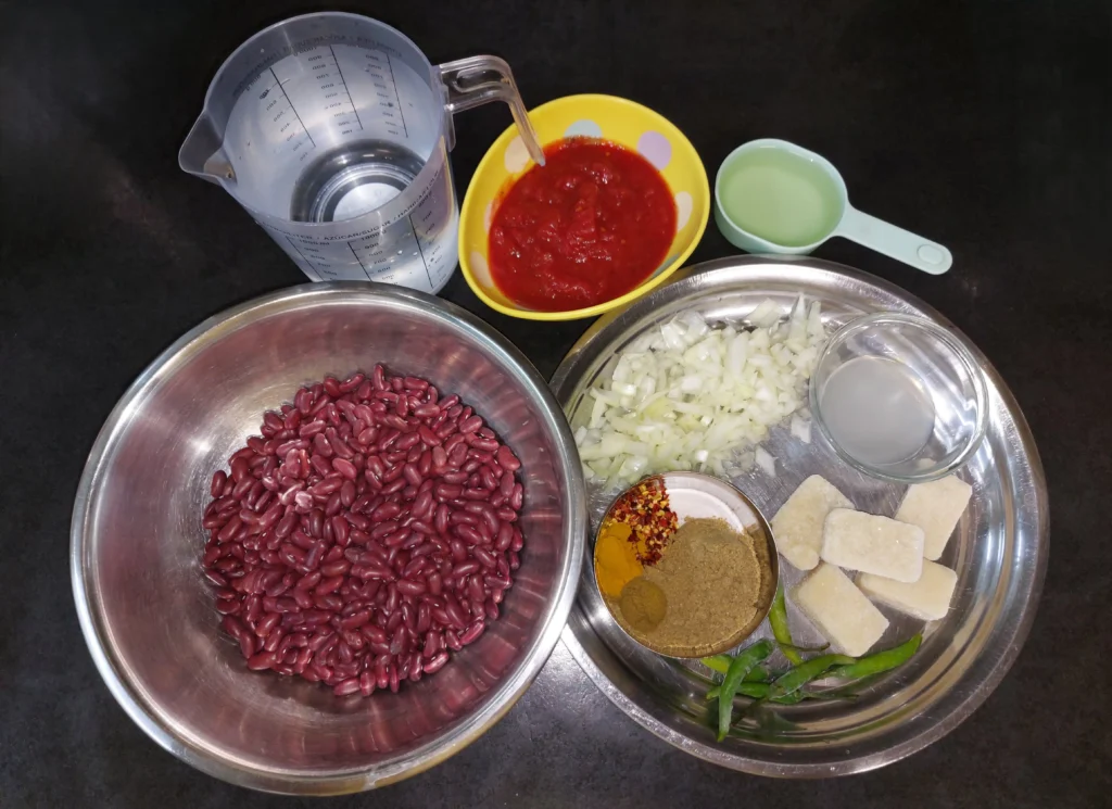 All ingredients required for rajma dal (water, tinned tomatoes, sunflower oil, kidney beans, yellow onion, lemon juice, spices, green chilli peppers, frozen garlic cubes)