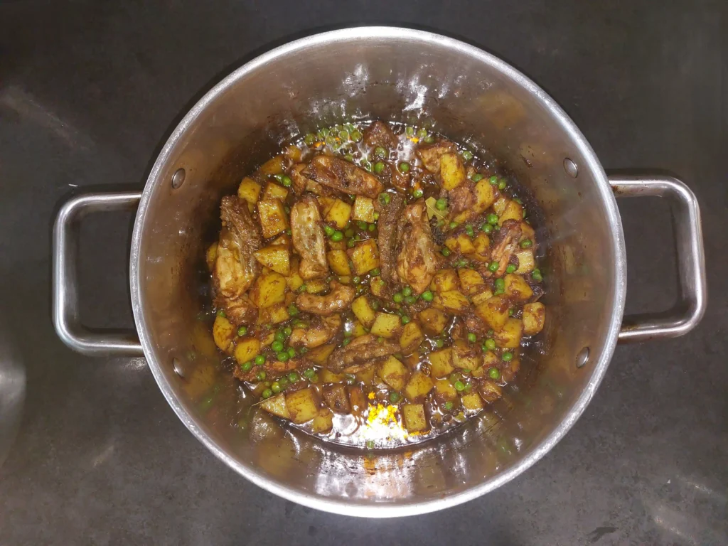 Potatoes and peas are cooked